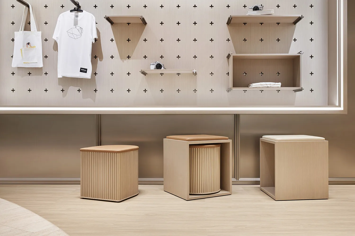 A minimalist retail storefront with wooden furniture and shelves.