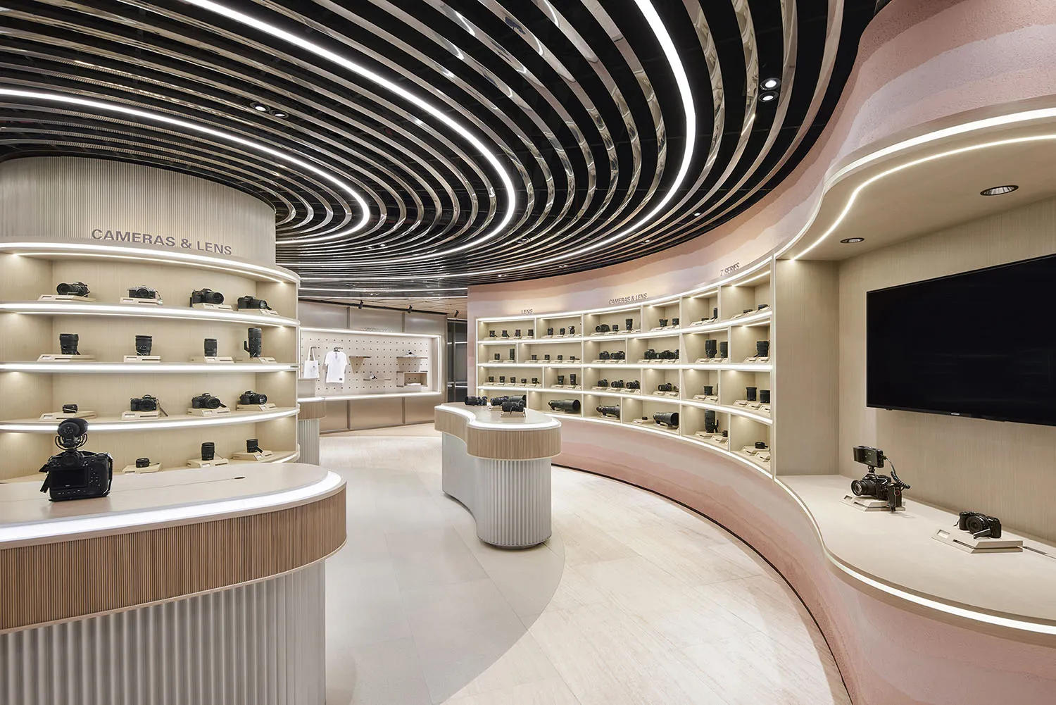 Modern camera store featuring light wood, concrete, and curved panels