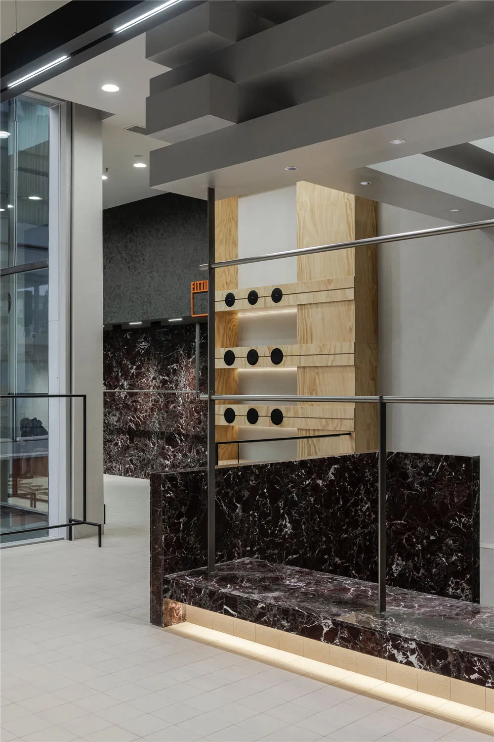A modern interior featuring marble and wood elements.