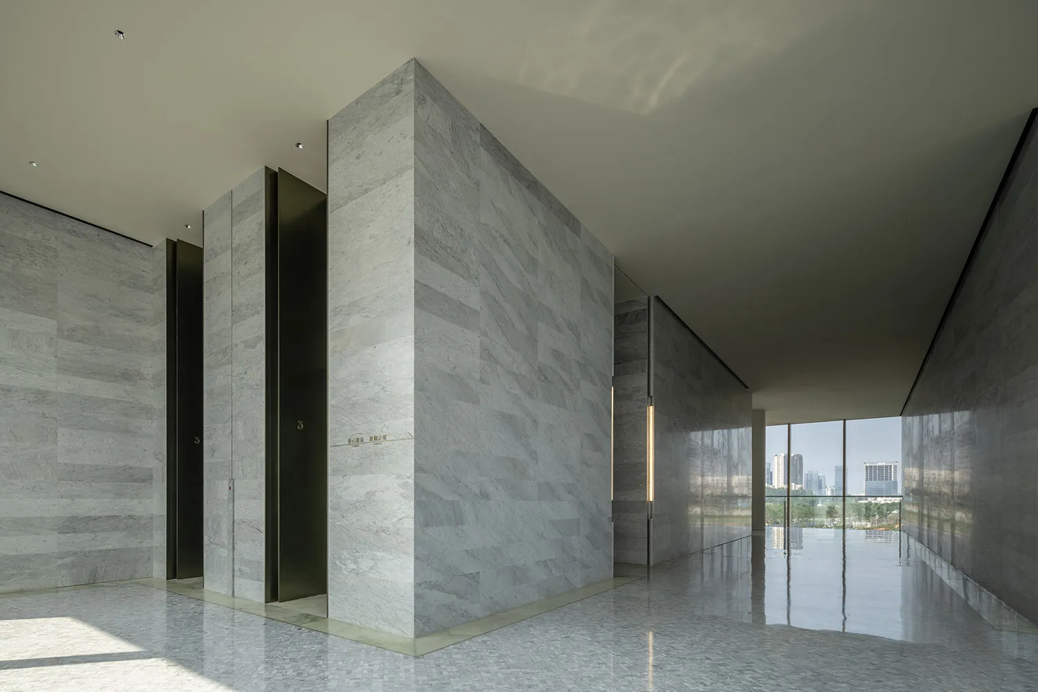 A modern marble lobby interior with minimalist design and sleek, polished finishes.