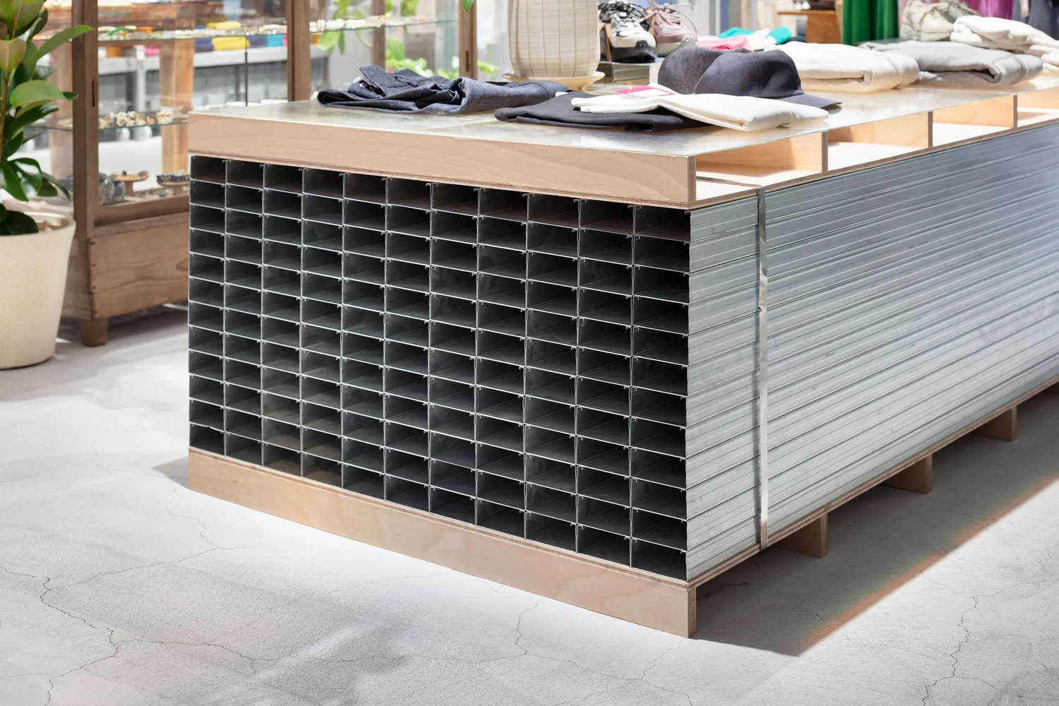 A modern retail display featuring a metal grid structure and industrial finishes, showcasing organized and structured present