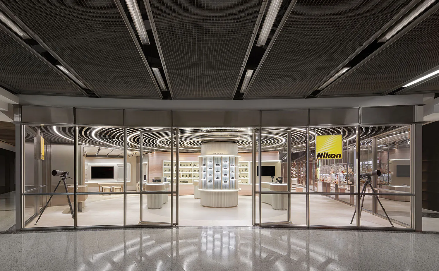Modern retail storefront with glass walls and marble flooring.