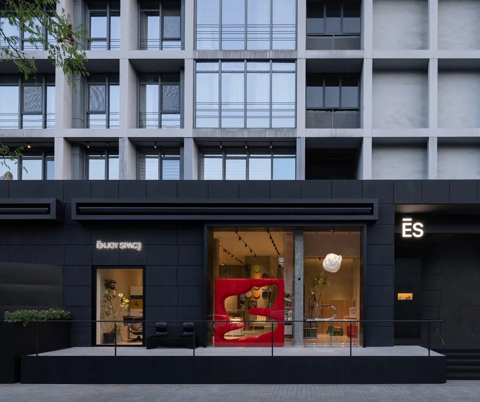 Modern retail storefront with black, concrete, minimalist design.