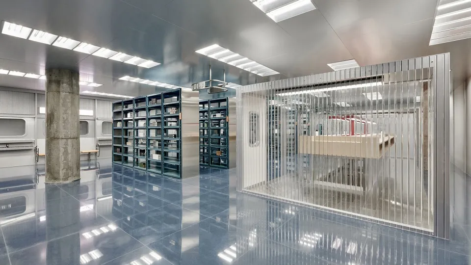 Modern industrial-style library with metallic shelving and minimalistic design