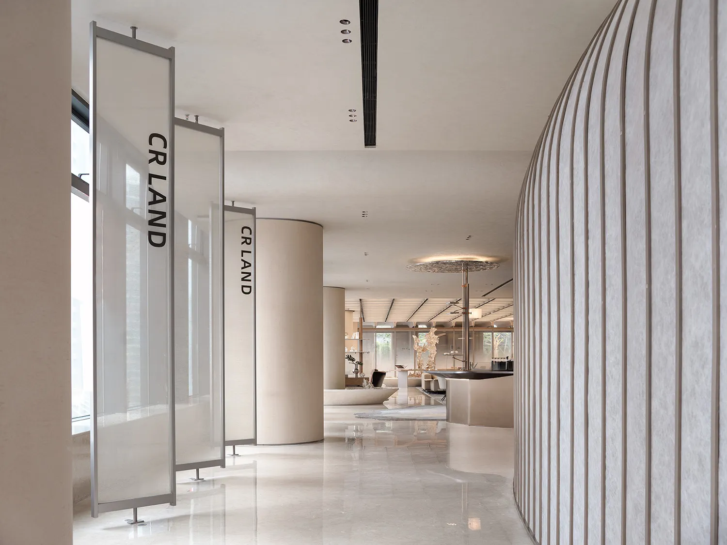 A minimalist lobby featuring glass, marble, and metal elements.