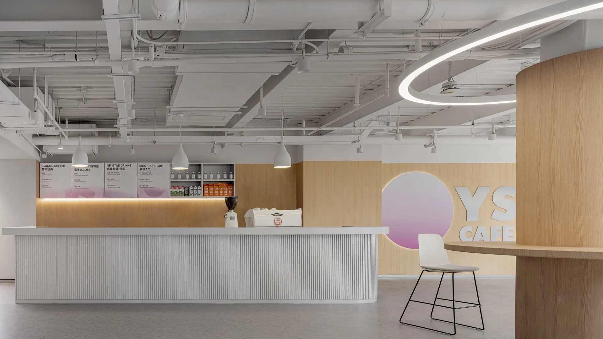 Modern coffee shop with minimalist design featuring white wood accents and concrete elements.