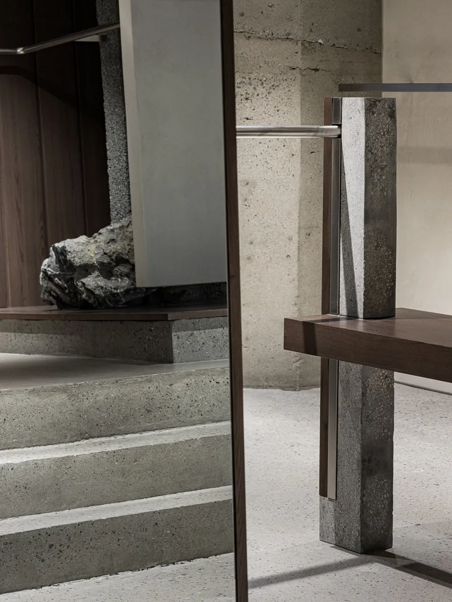 Modern interior design featuring concrete stairs and a wooden platform.