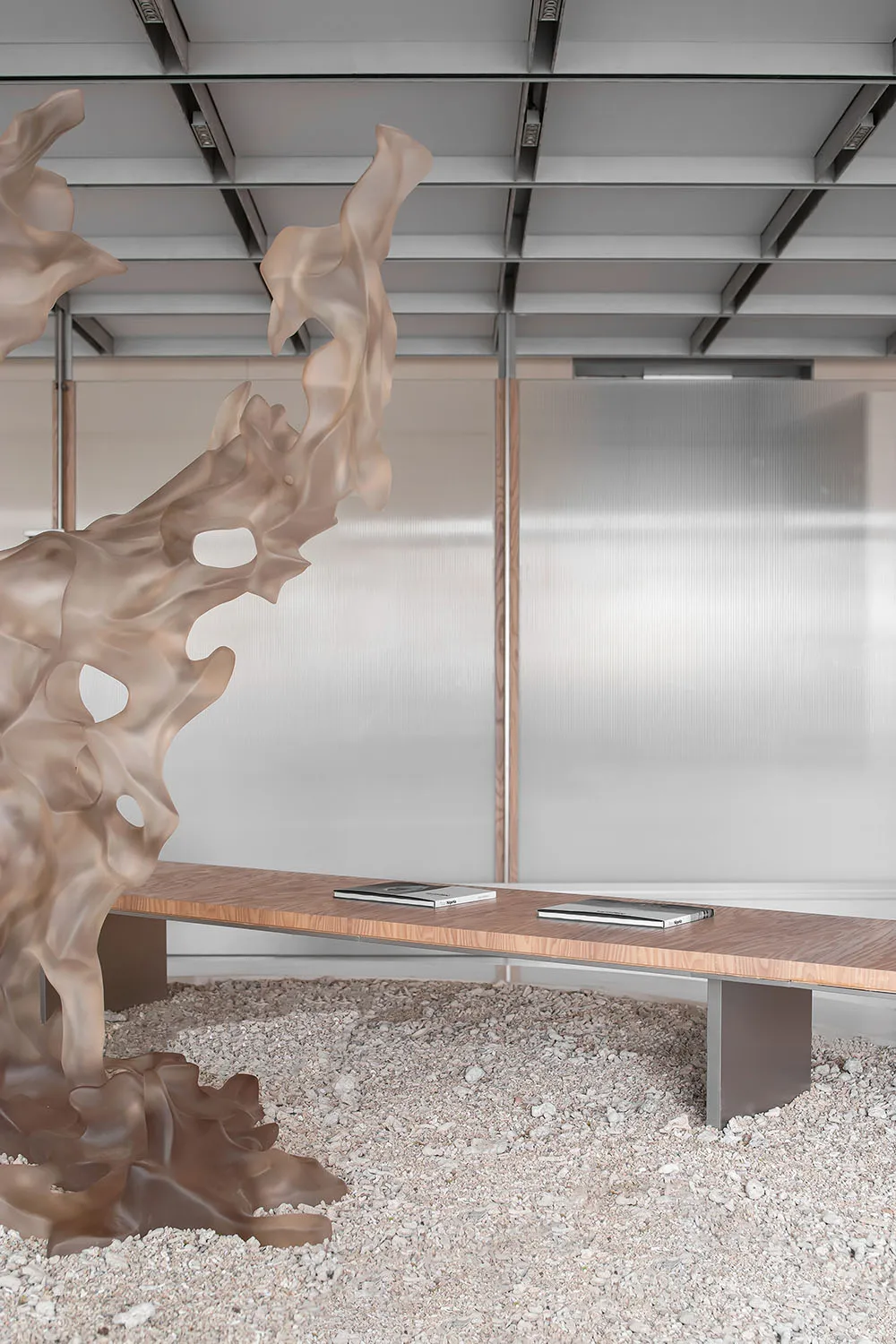 Minimalist modern office space featuring transparent glass and fiberglass elements.