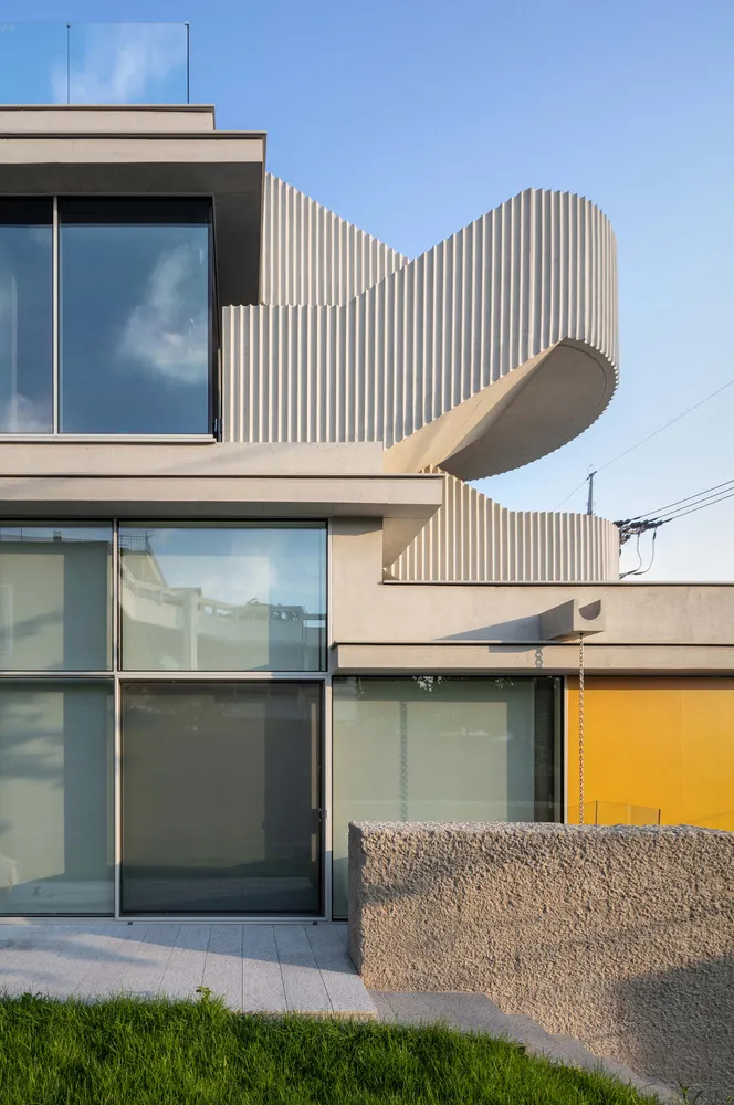A modern building with a concrete facade and large windows