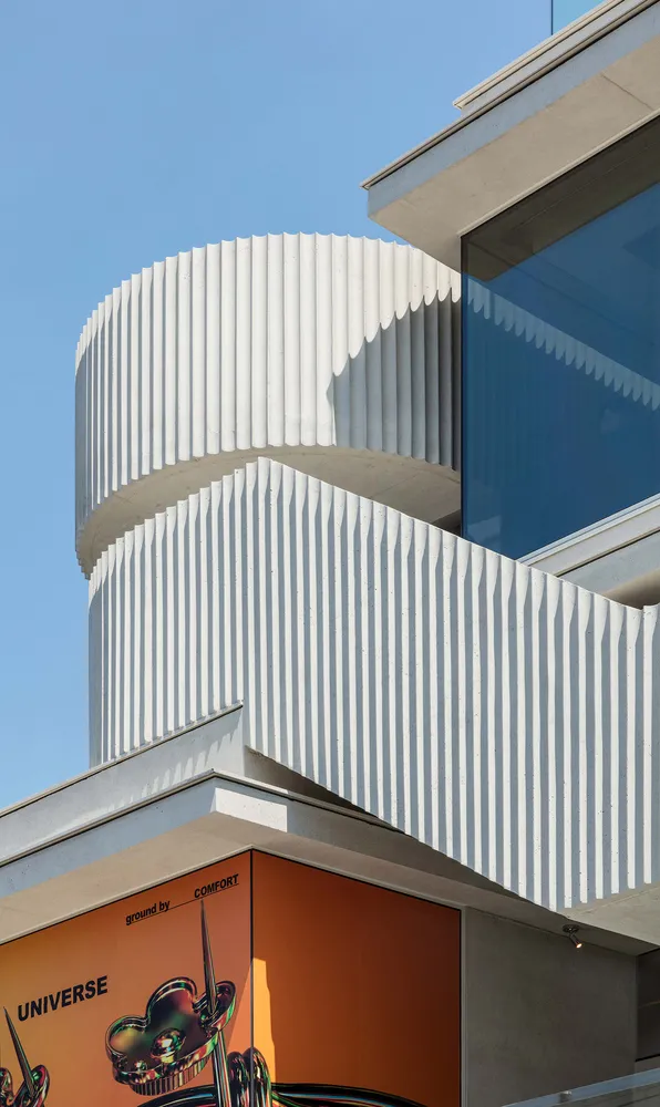 A modern building with a white exterior featuring white vertical bars.