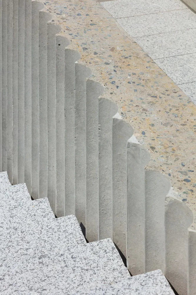 Modern stairs with concrete steps and granite railings