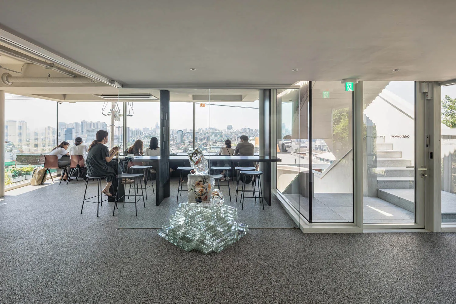 A modern cafe interior with glass blocks and concrete features.