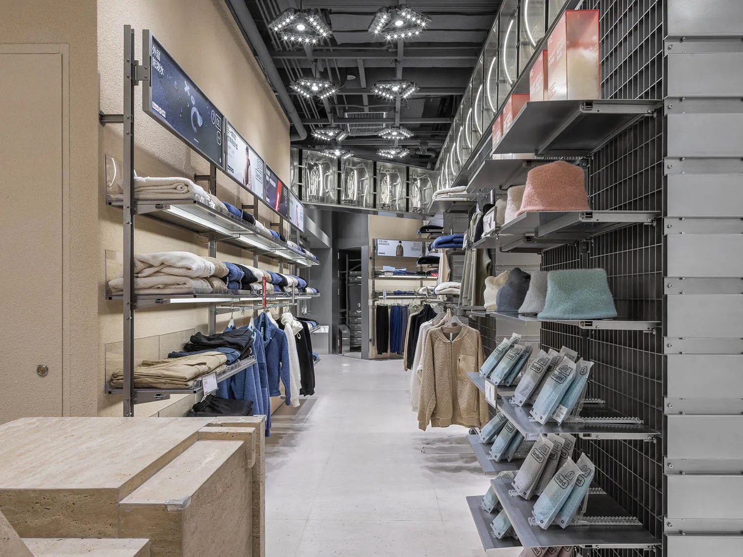 Modern retail store interior with clothing racks and shelves.