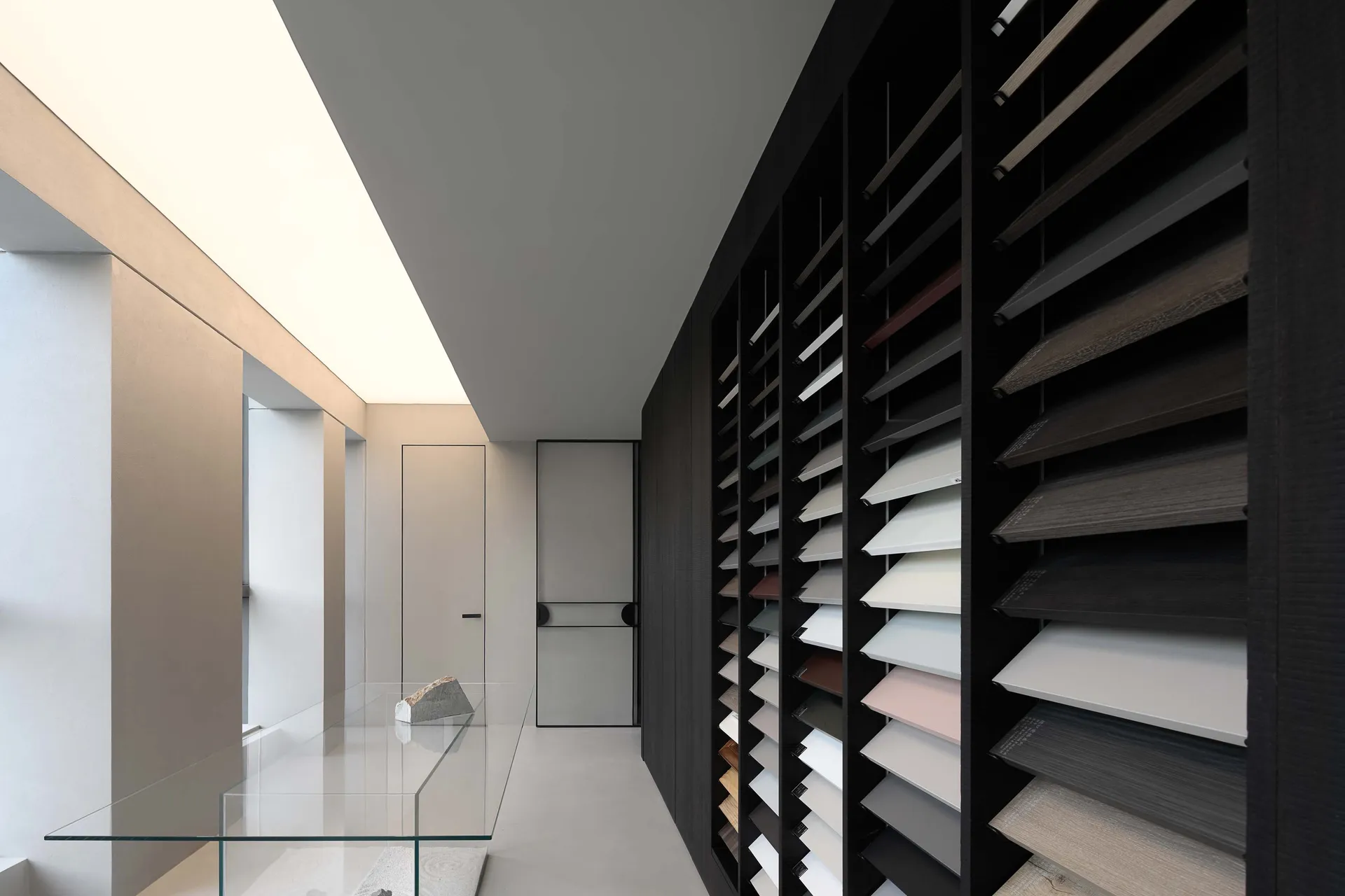 A modern interior design featuring a wall display of various colorful shades of paneling materials.