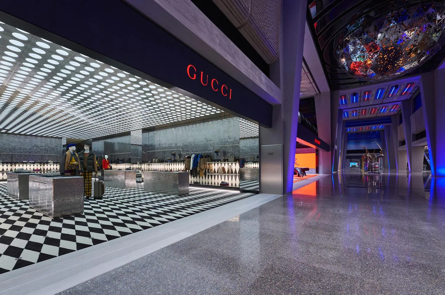 Modern retail storefront with geometric design and glass and concrete materials.