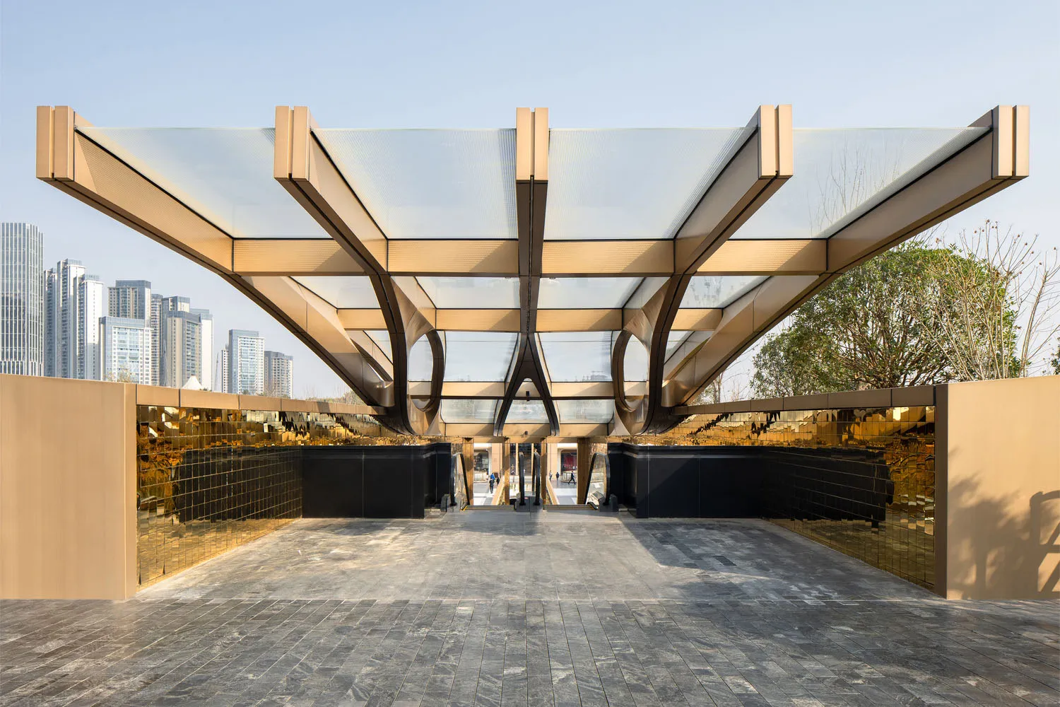 A modern public entrance featuring glass, metal, and cement materials
