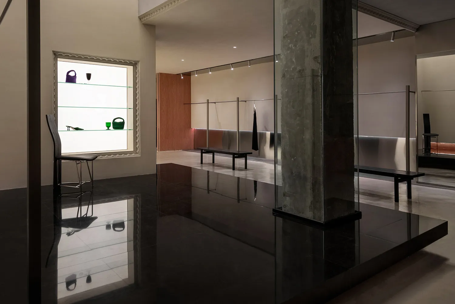 Retail storefront with black reflective floor concrete walls
