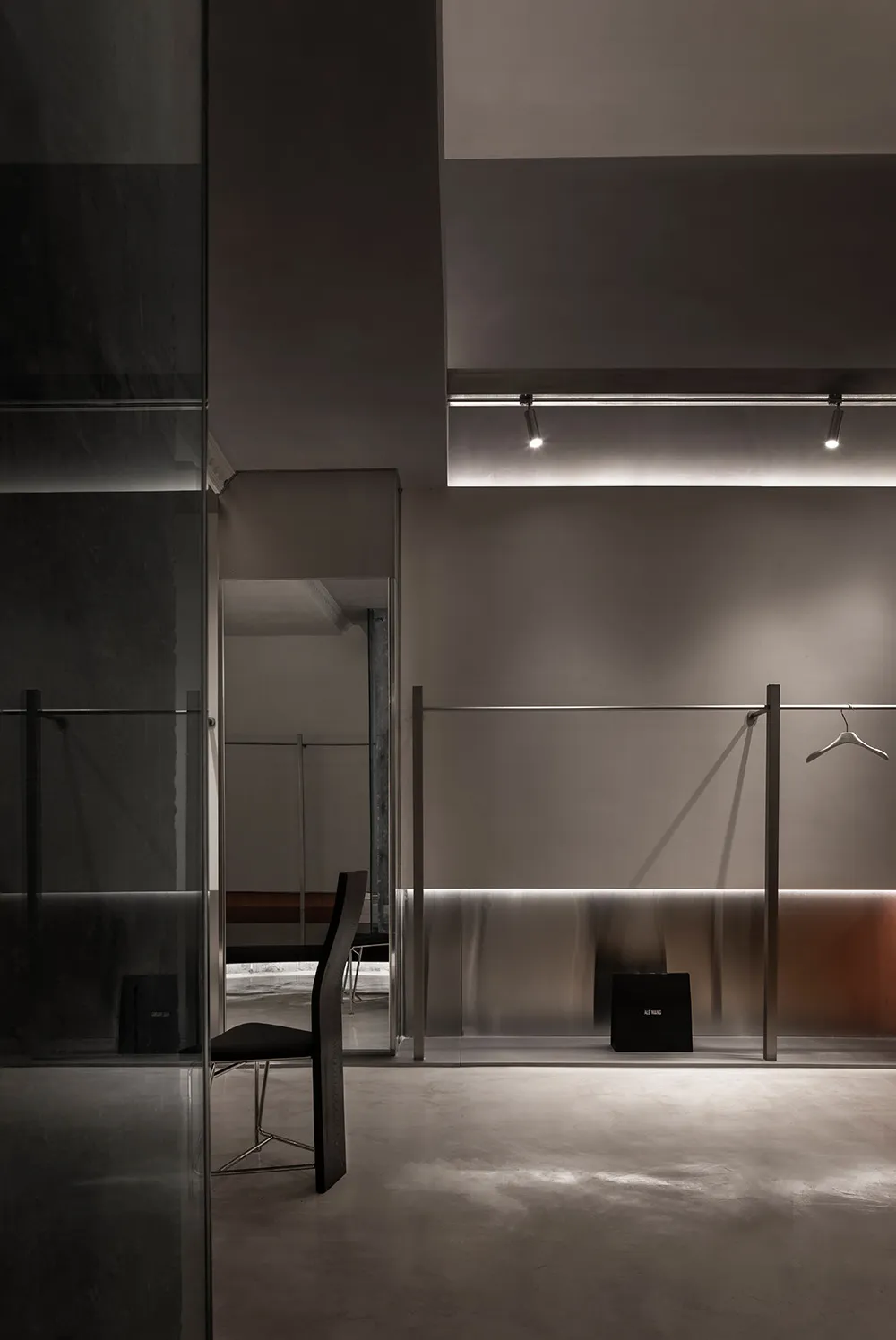 Modern minimalist clothing store with metallic finishes.
