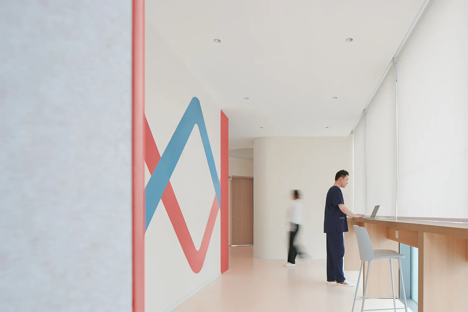 Minimalist design with white walls and red and blue patterns in a hospitality interior setting