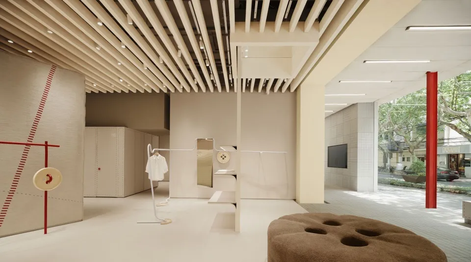 A minimalist retail store featuring wood, concrete, and glass materials.