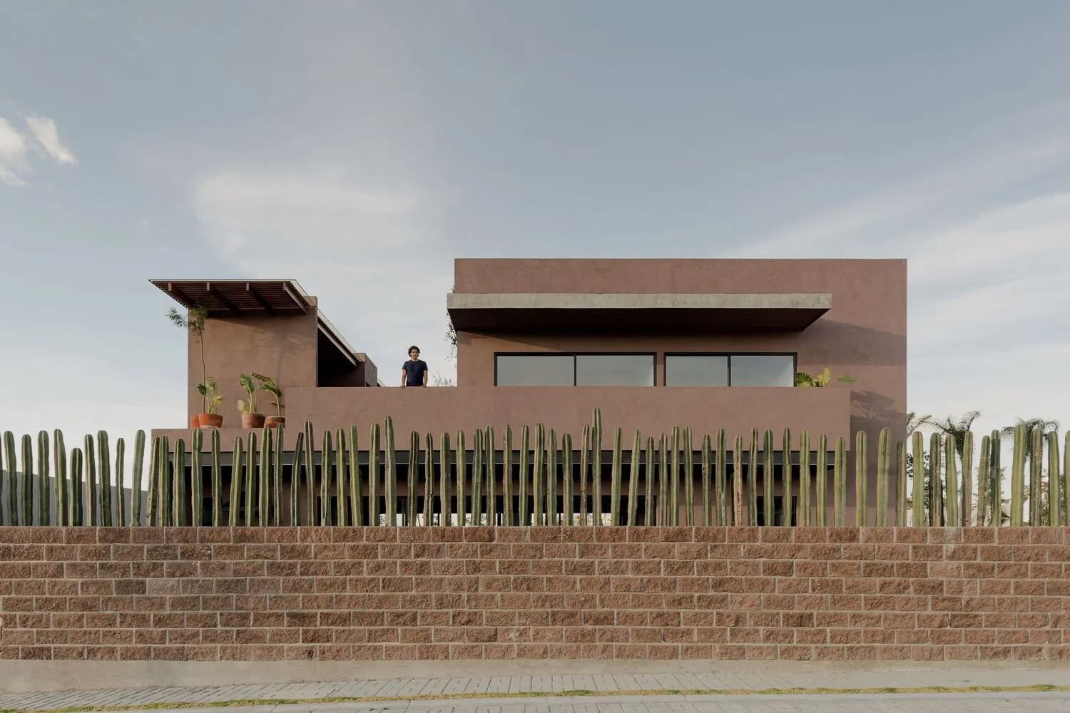 A modern house with concrete and glass exterior materials.