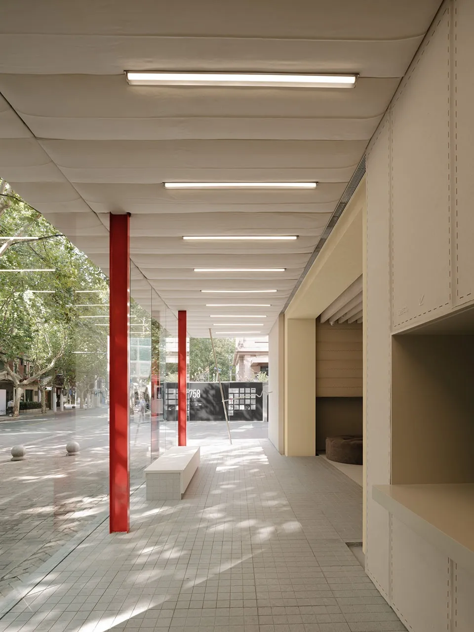 Modern retail store with concrete walls and red columns