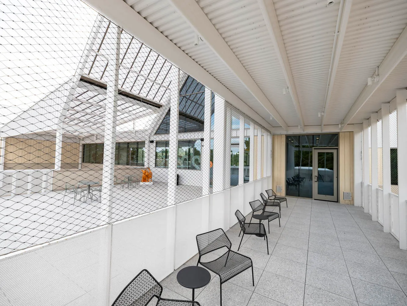 Modern, minimalist design featuring industrial metal wire furniture and white steel elements.