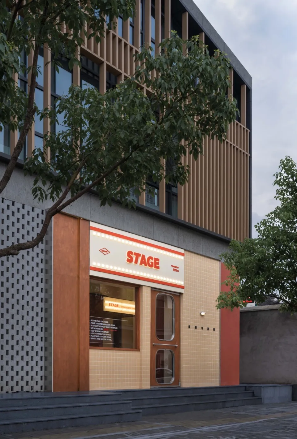 Shopfront with modern, minimalist design featuring wood, glass, and metal materials.