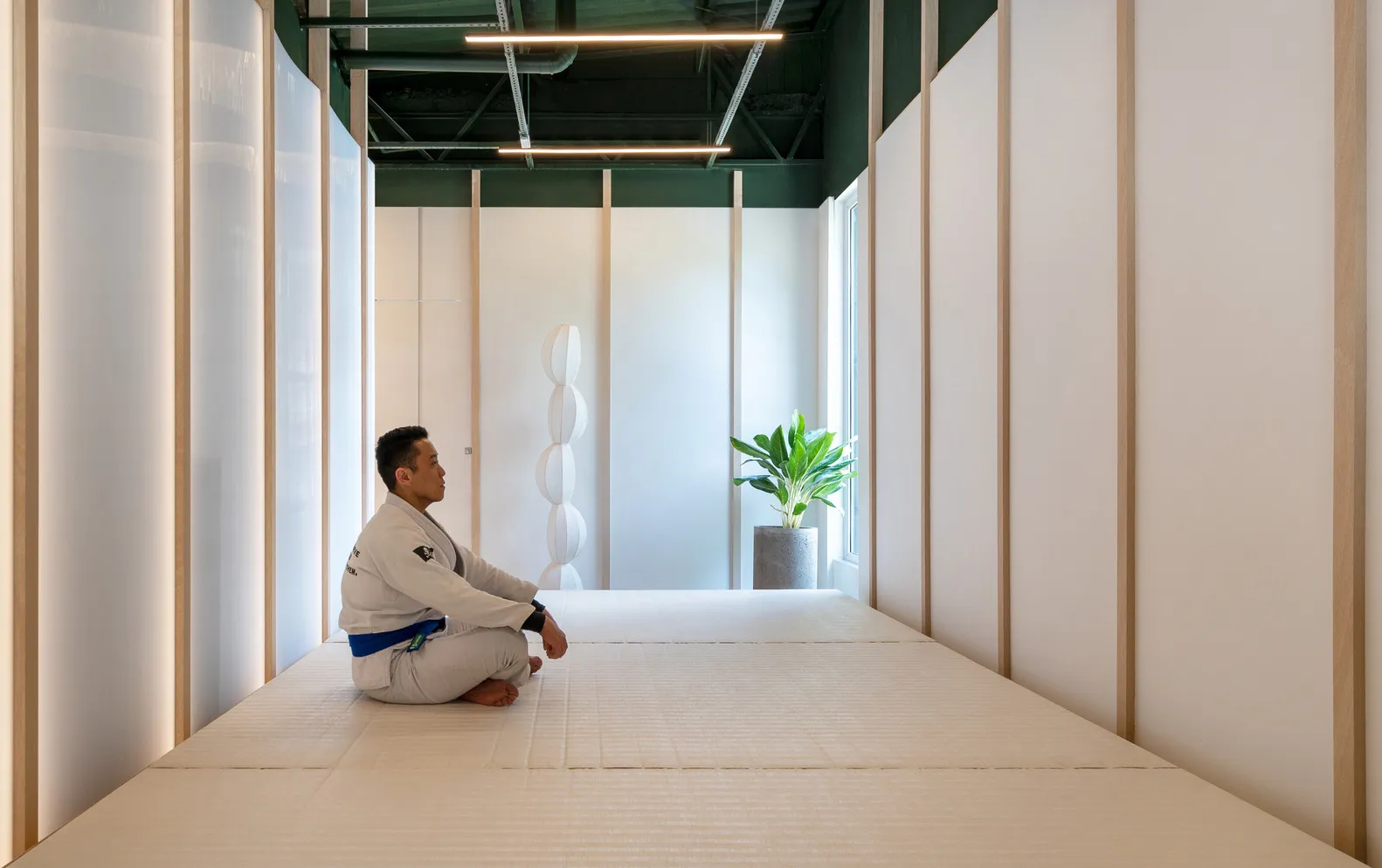 A minimalist exercise room with a white interior, serene atmosphere, and a focus on functionality.