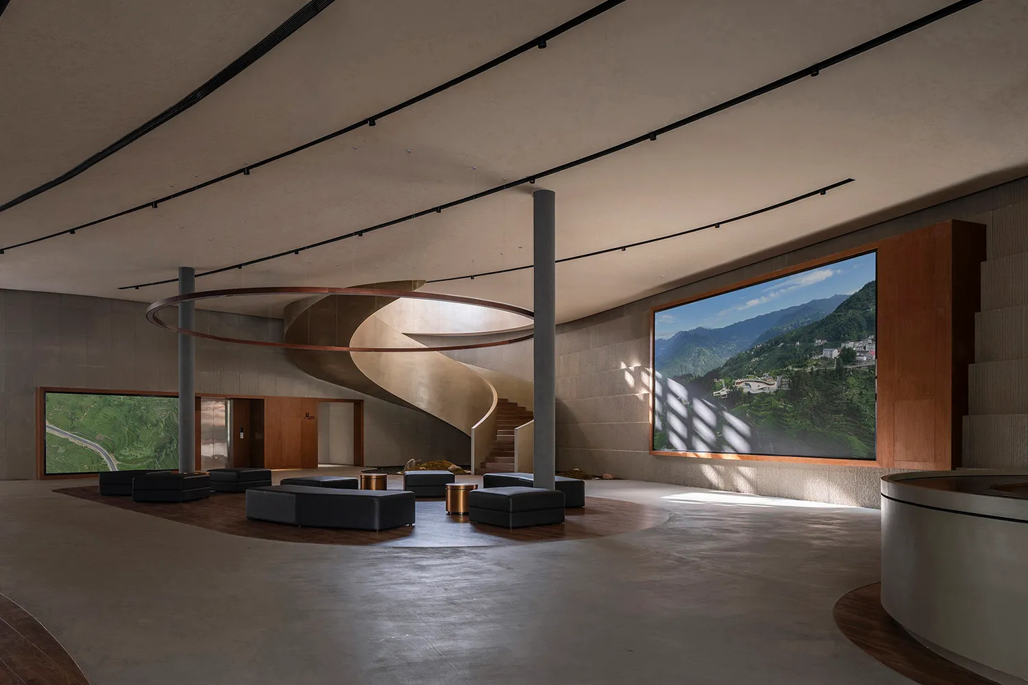 Contemporary lobby with concrete walls and spiral staircase
