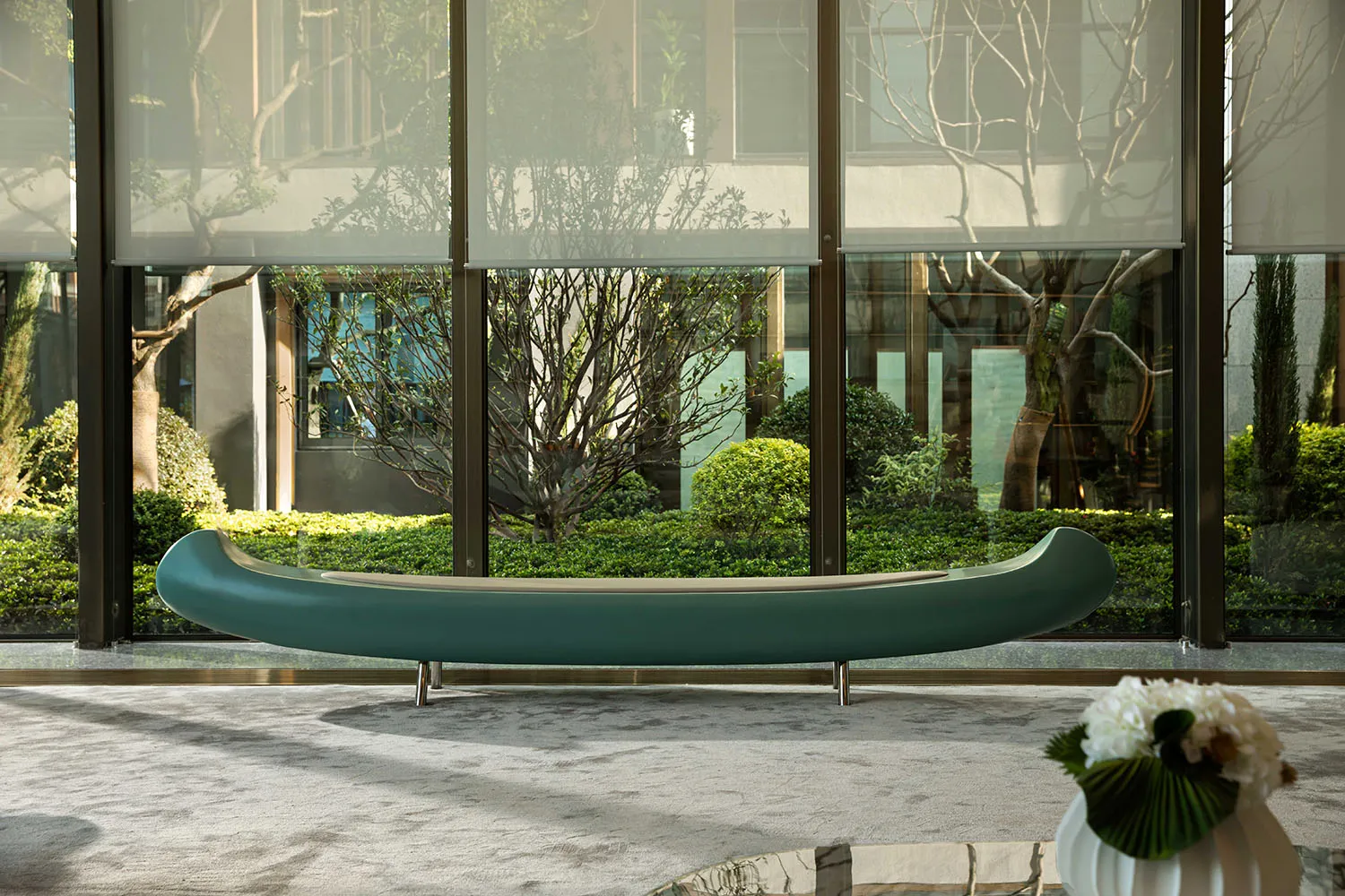 Modern lobby featuring a glass window with a futuristic, contemporary interior design and seating furniture.