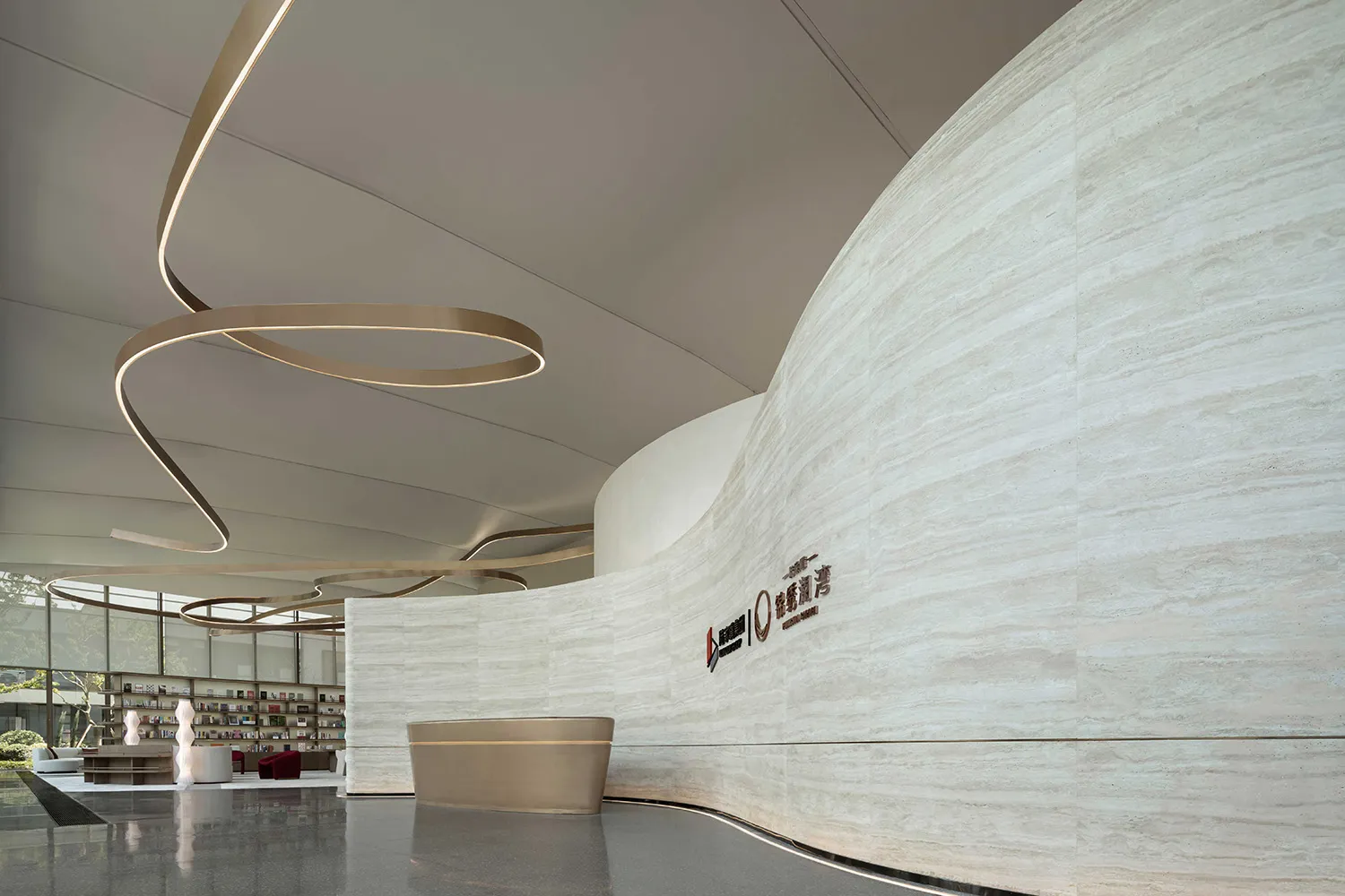 A modern lobby with a marble wall and circular lighting fixture