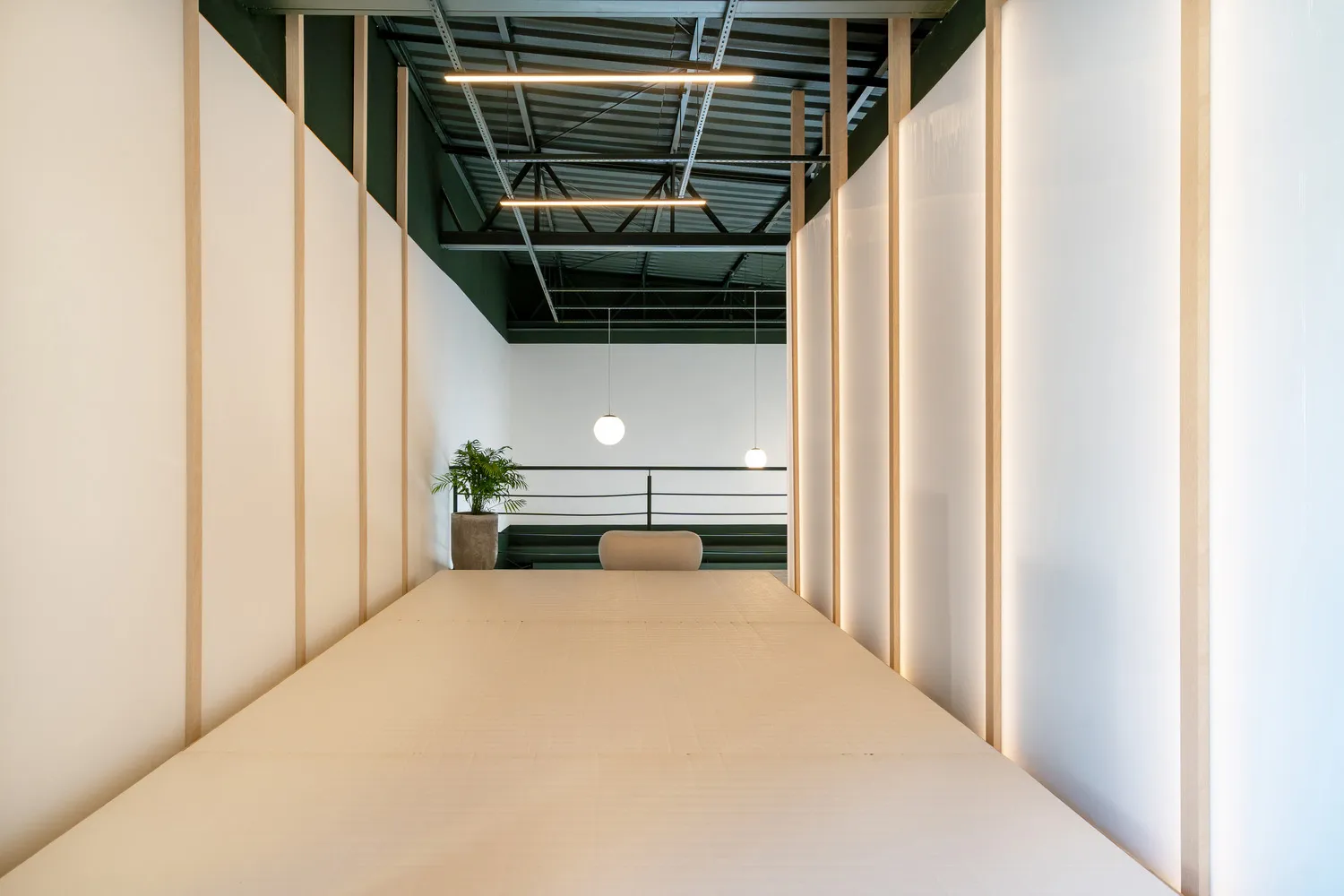 A modern minimalist living room with white paper flooring.