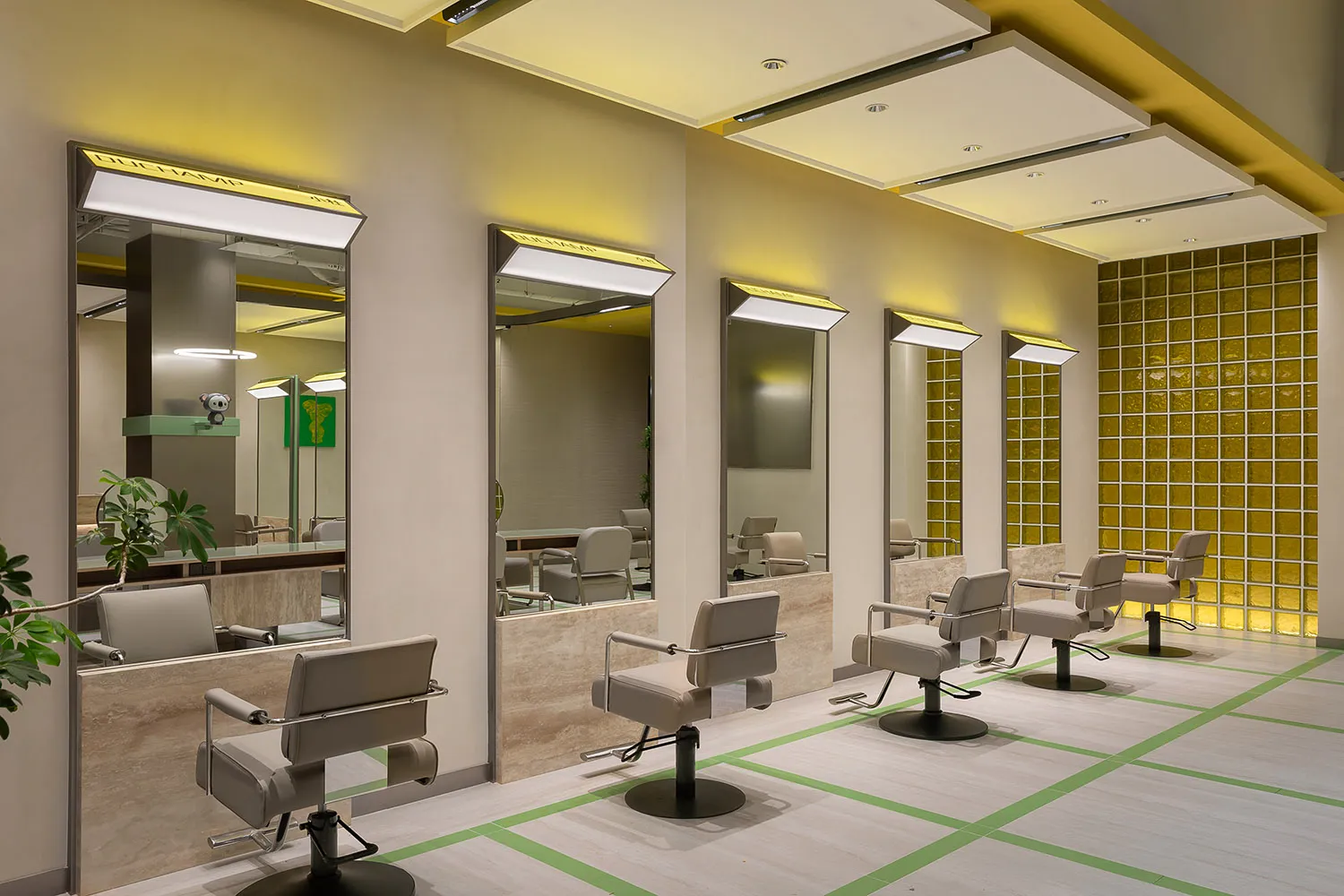 Modern, spacious salon interior with sleek, contemporary styling, illuminated by soft, ambient lighting.