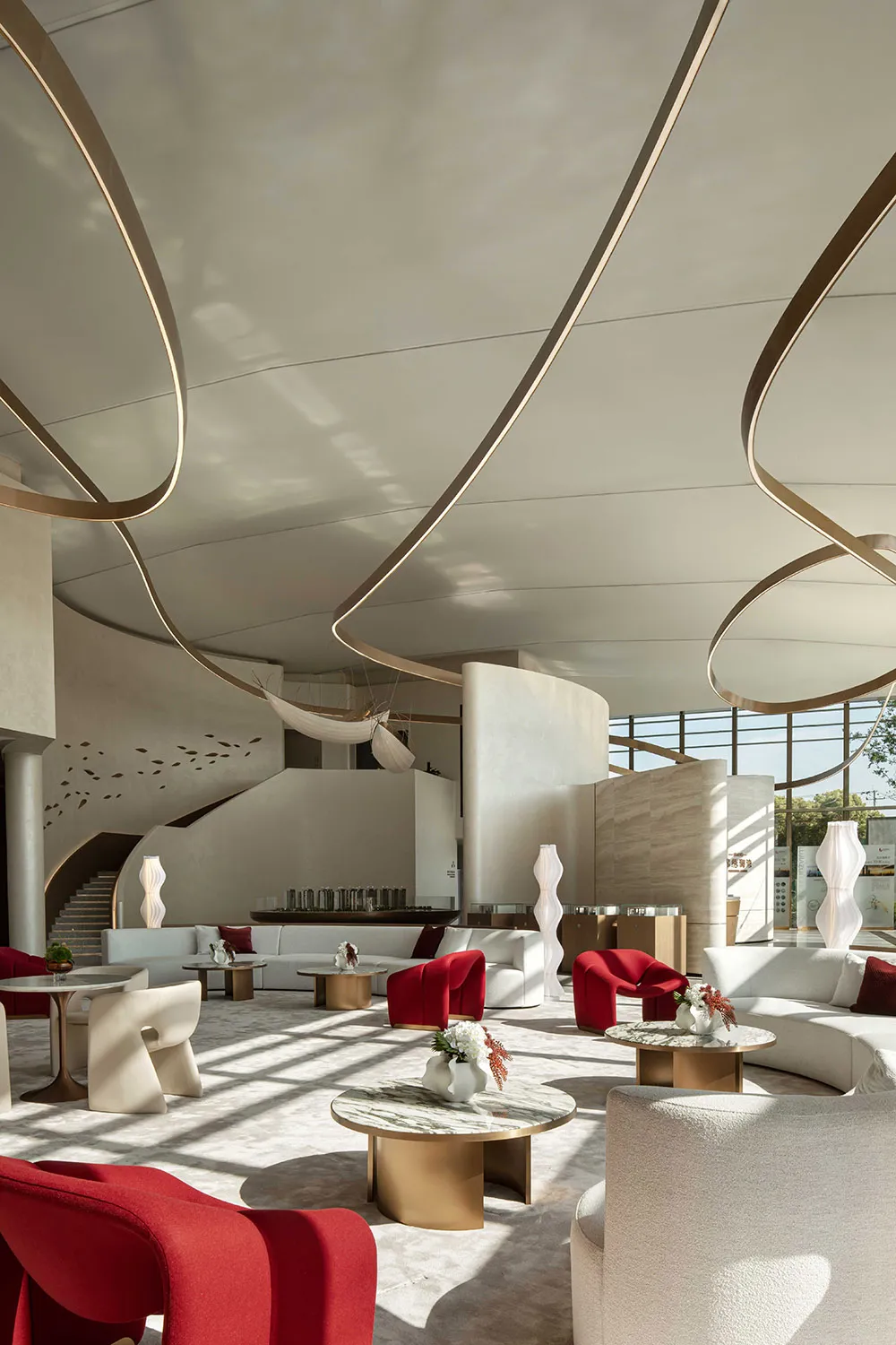 Modern lobby featuring sleek concrete, marble, and glass materials.