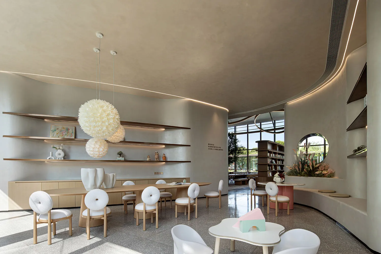 Minimalist design in a contemporary restaurant interior with wooden tables, concrete walls, and glass partitions.