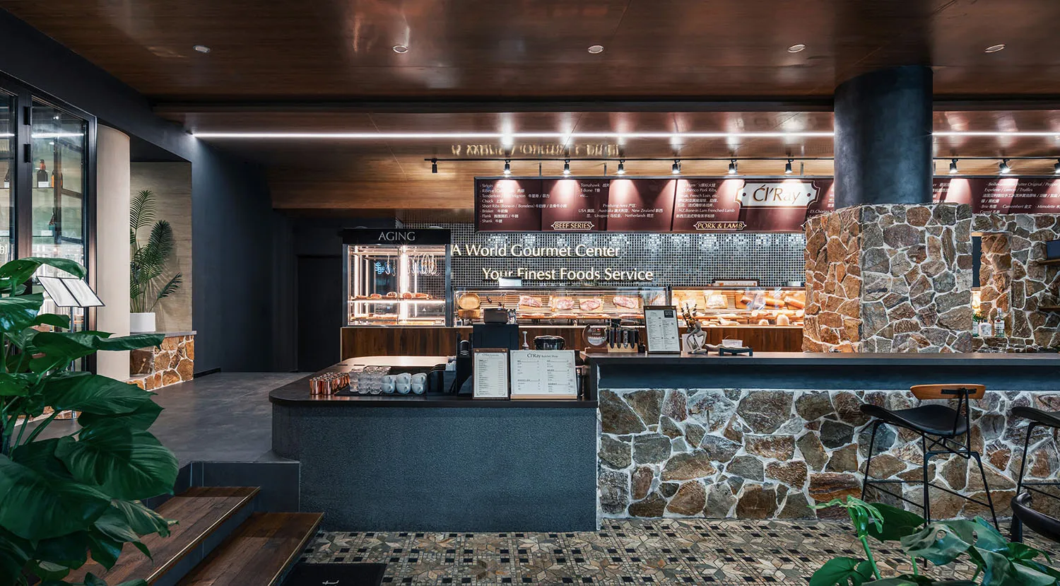 Modern restaurant interior with stone, wood, and metal materials.