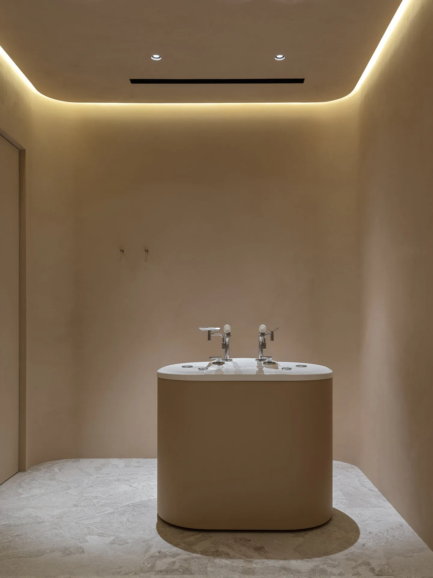 Minimalist bathroom with a white ceramic tub and sleek, modern design.