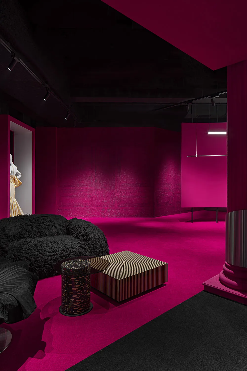 A modern retail storefront with pink paneling on the wall.