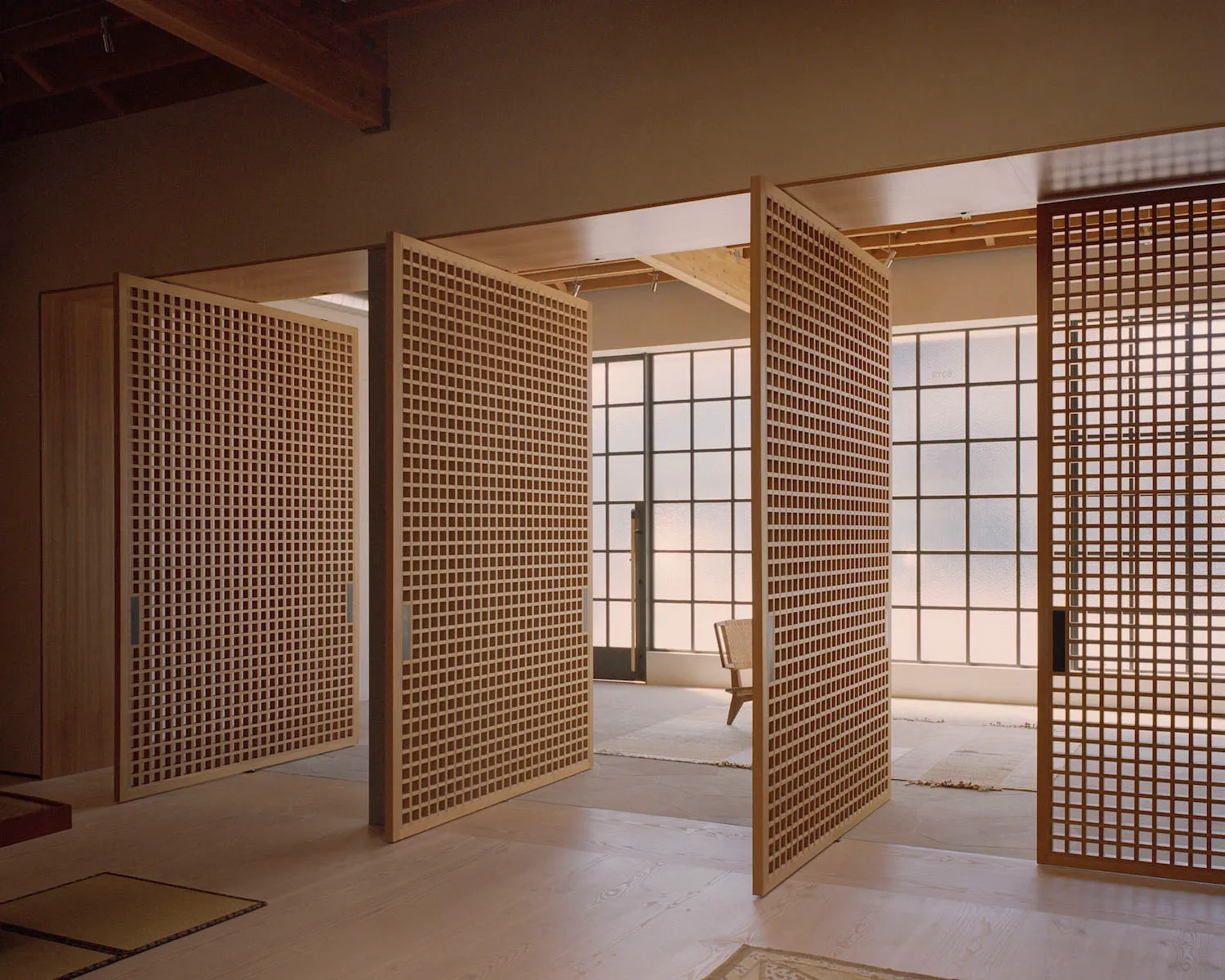 Open-concept space featuring a timber frame design with a minimalist aesthetic.