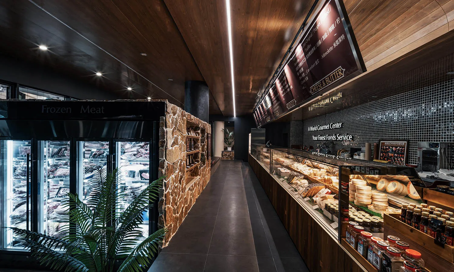 A retail grocery store with shelves displaying various products, stone accents, and a wooden ceiling and floor.