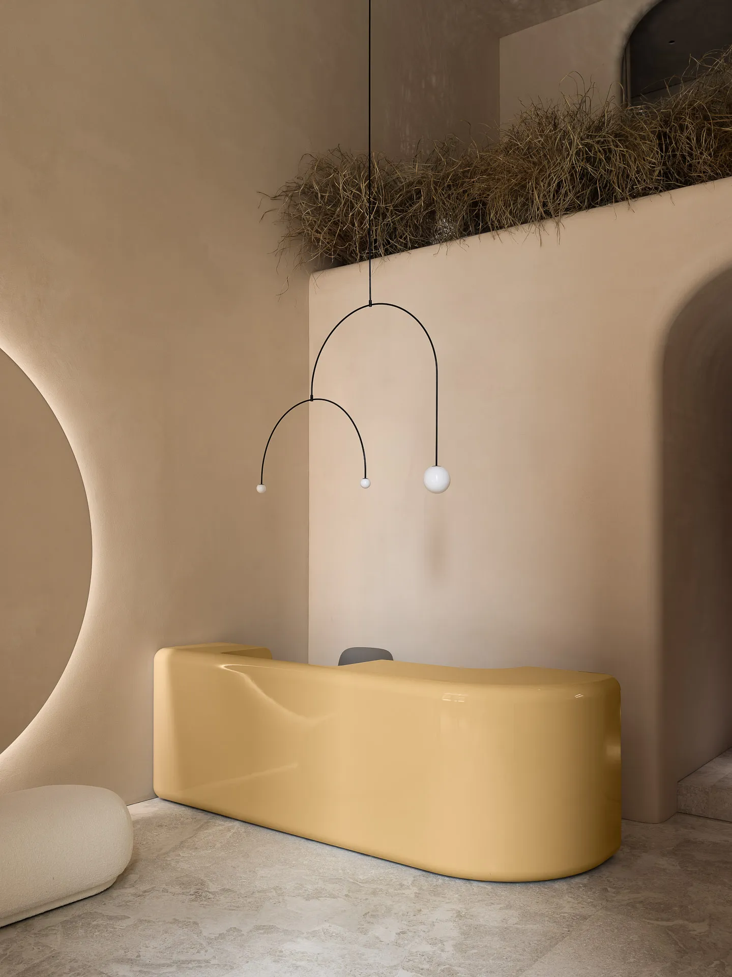 A sleek, modern reception desk made of polished, yellow concrete.