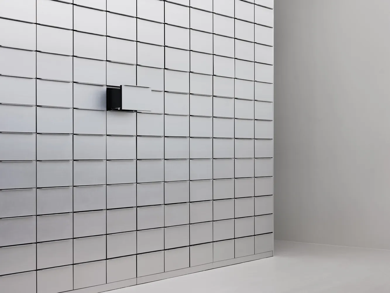 A minimalist storage unit with white metal boxes arranged in a grid pattern.