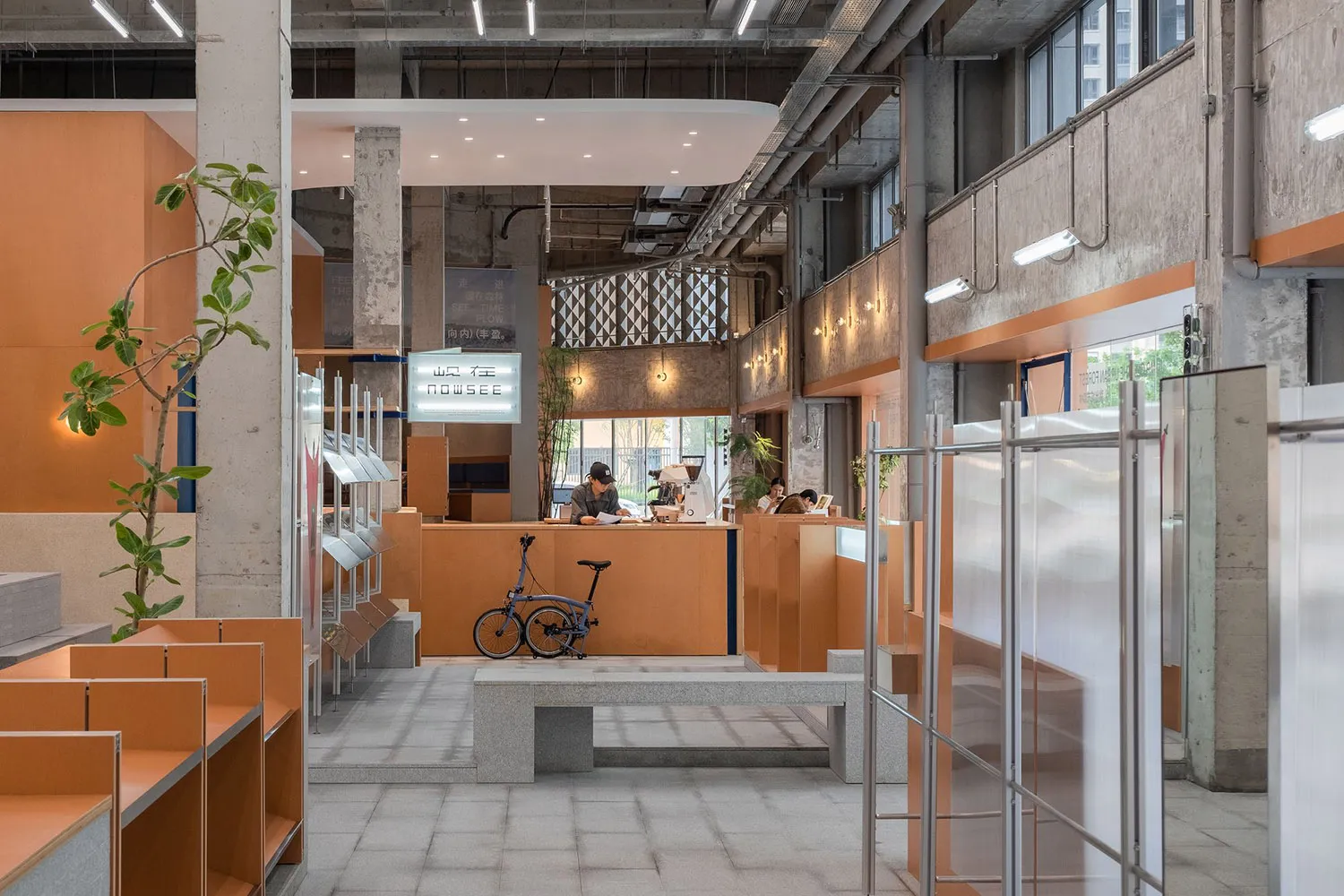 Interior of a modern coffee shop featuring minimalist design with concrete walls and floors.