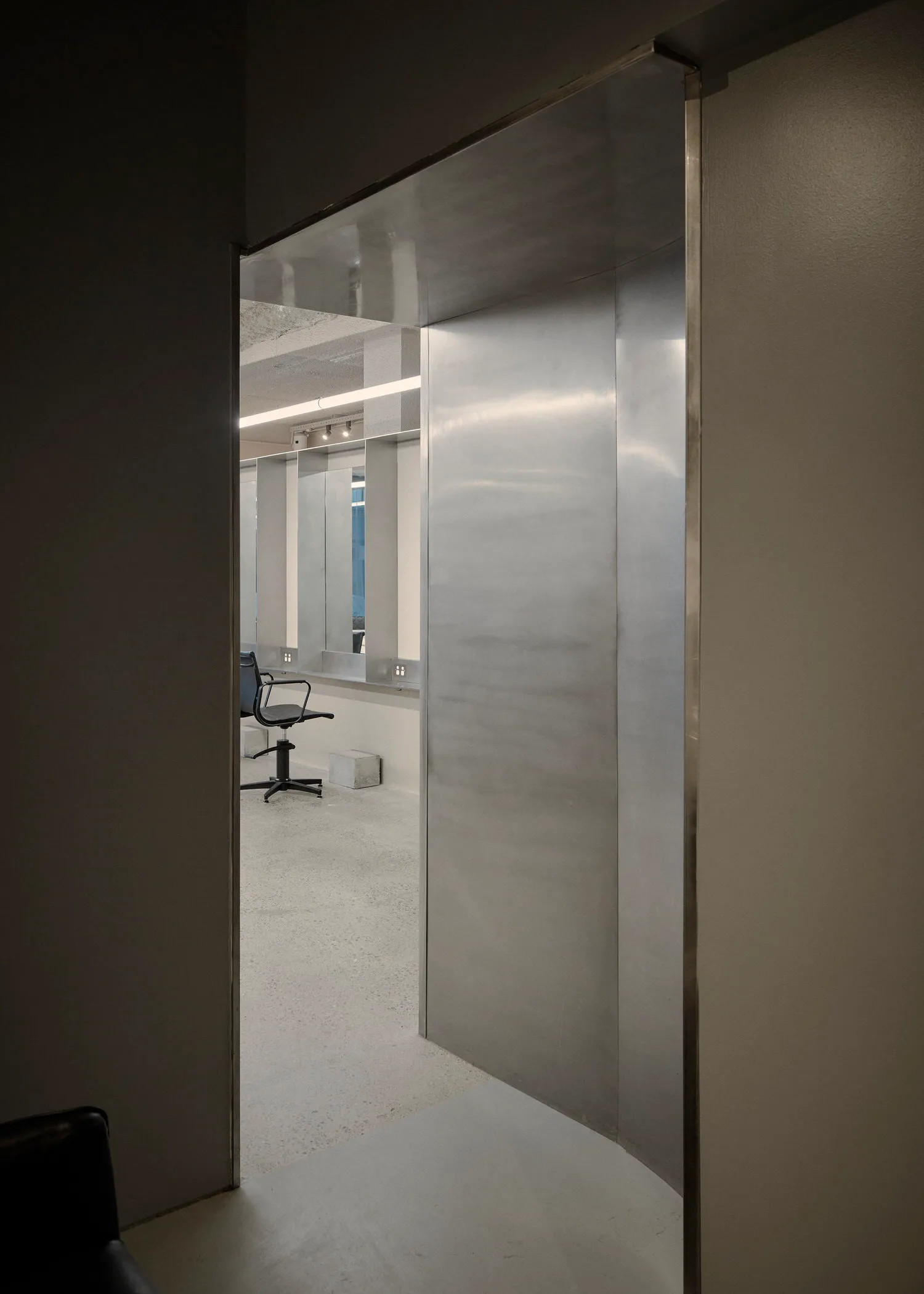 Modern interior design featuring metallic and glass elements.