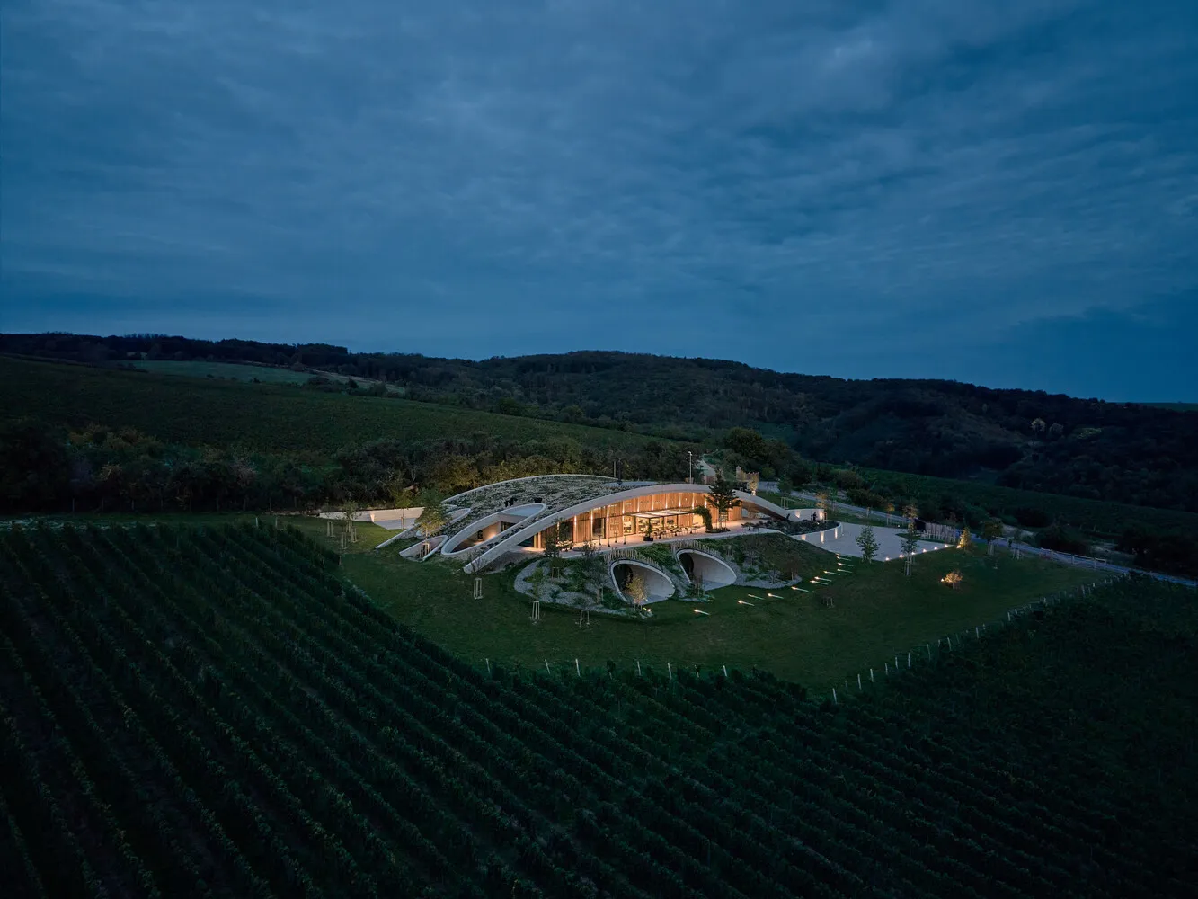 A modern wine tasting room with stone, glass, and wooden elements.