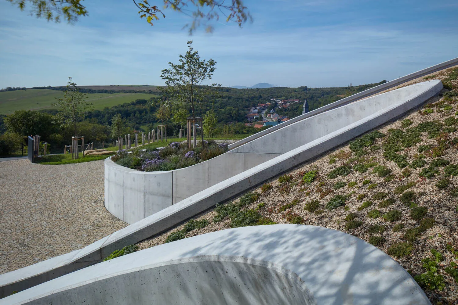 A modern landscape installation featuring concrete and gravel