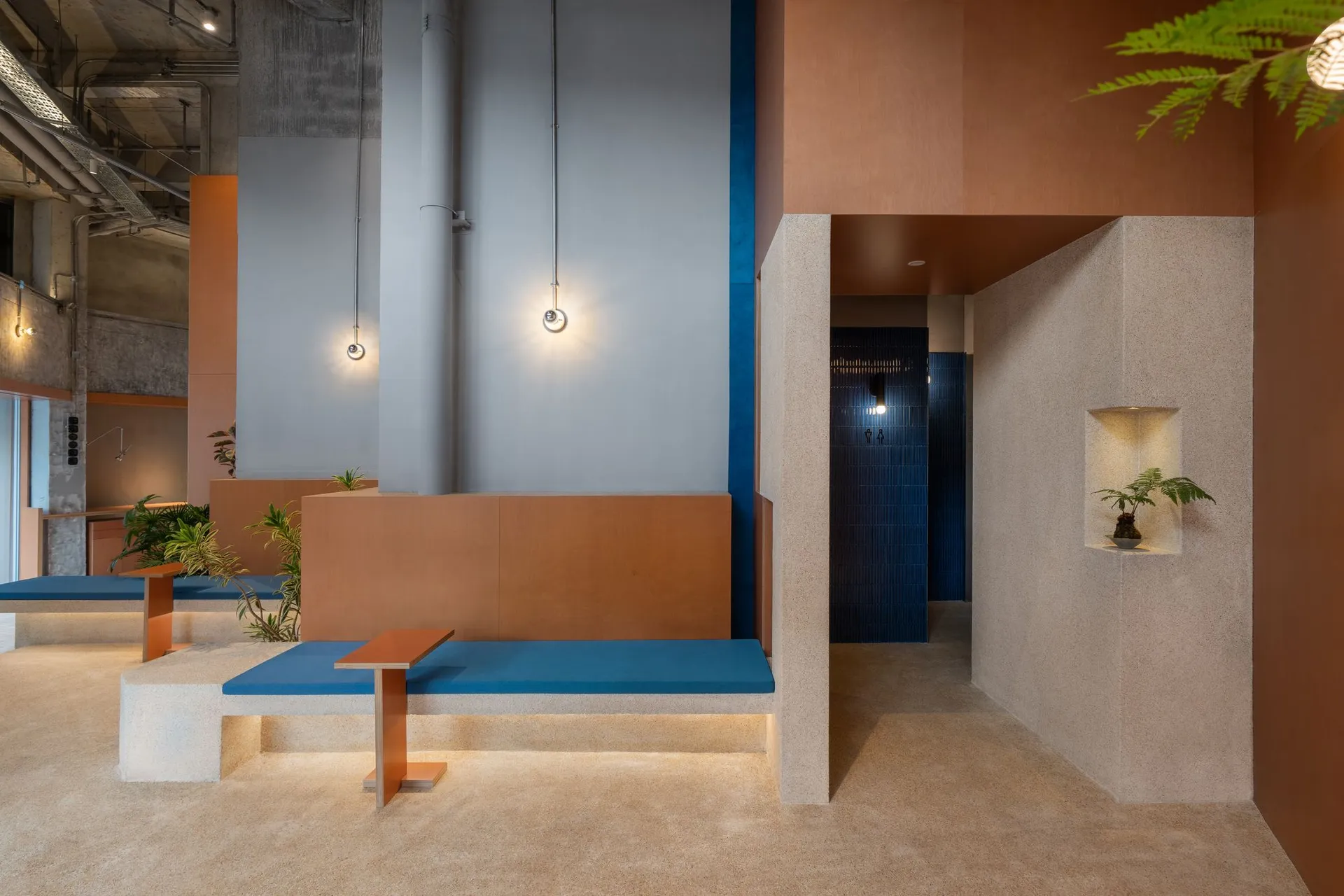 Industrial-themed coffee shop featuring concrete furnishings and minimalist design