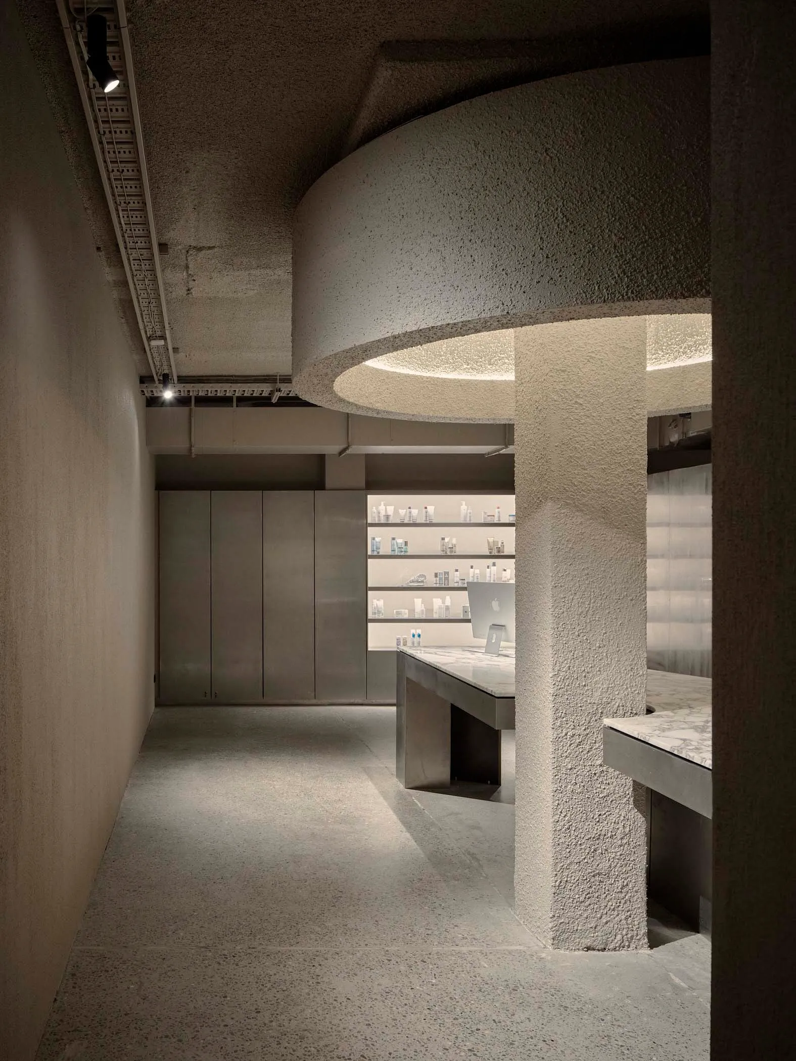 A modern retail storefront with concrete elements and minimalist design.