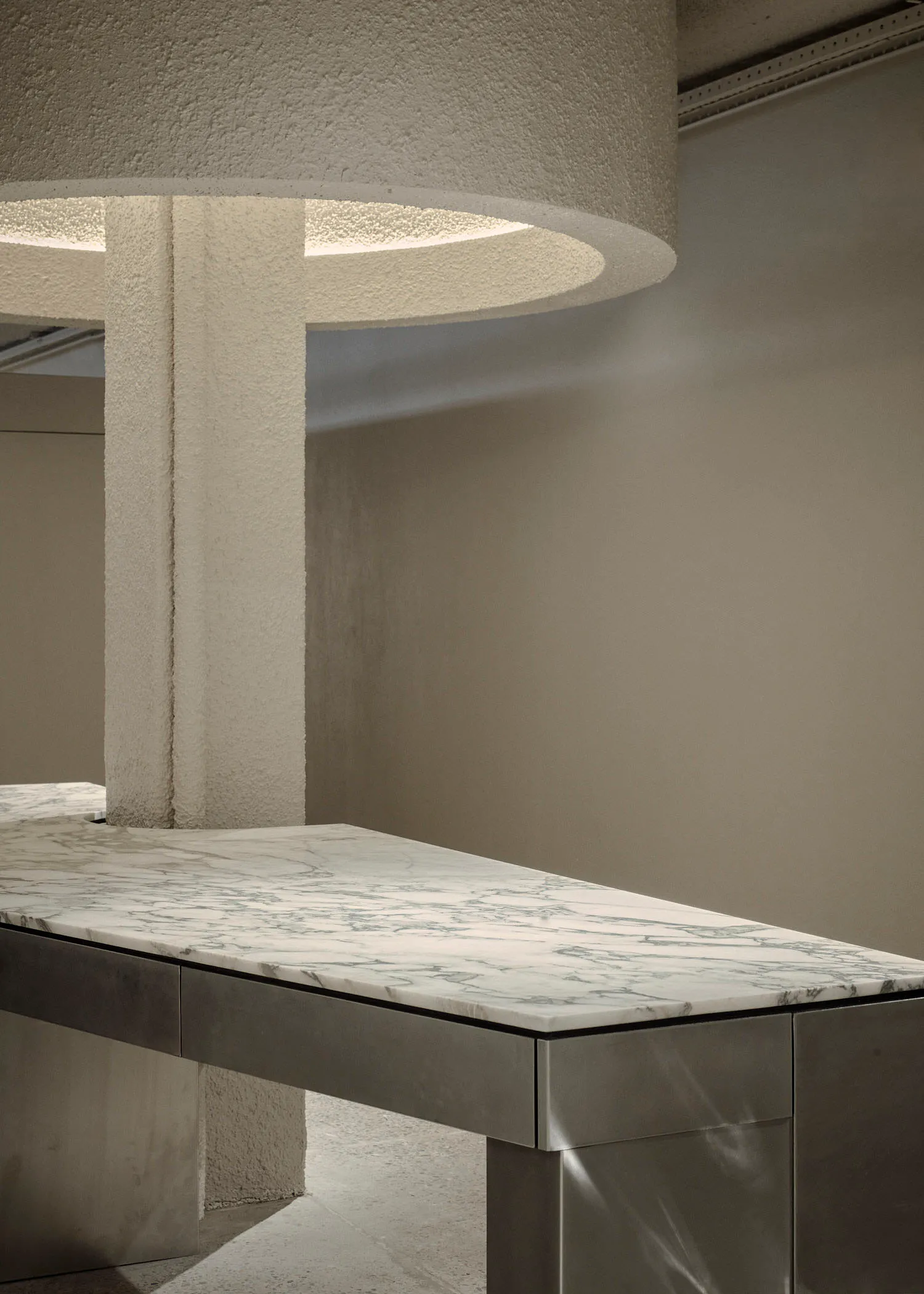 A modern interior featuring a marble and concrete countertop.